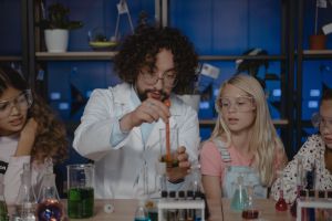 A group of students and teacher conduct an experiment.