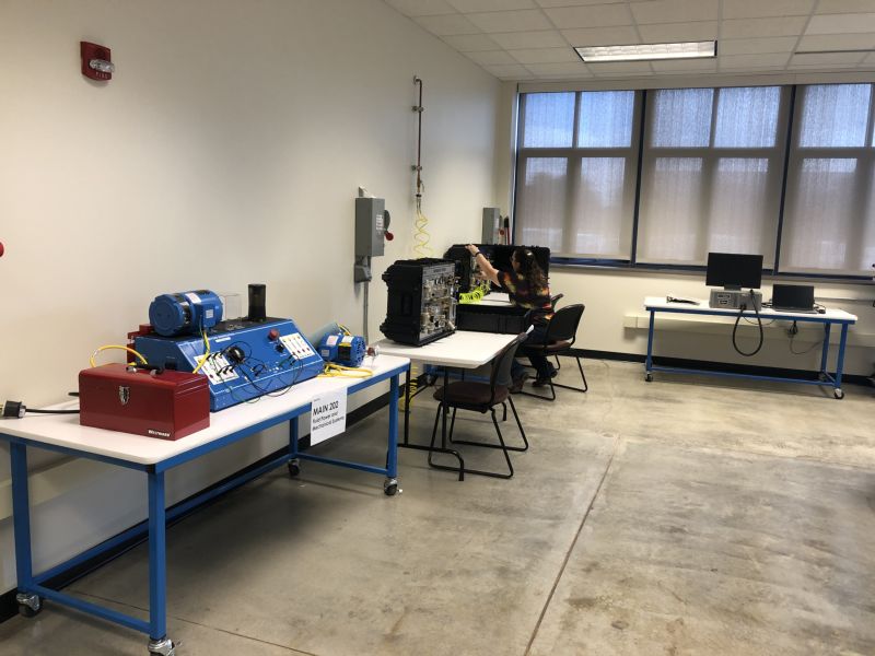 Instructor is setting up a mechatronics trainer for students to use in FLITE lab